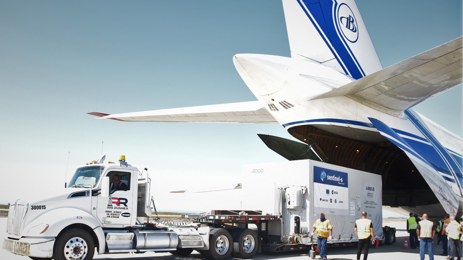 A photo of the spacecraft container being unloaded from a plane.